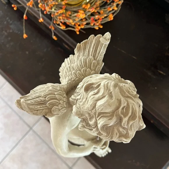 Resin angel statue on a ball 14 1/2 tall 8” wide cream colored